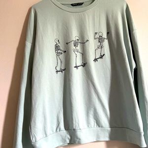 Skeletons on skateboards, mint green crewneck